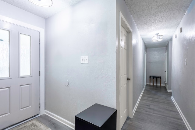 entryway featuring hardwood / wood-style flooring and a textured ceiling