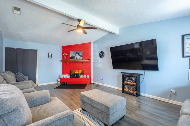 living room featuring ceiling fan, a textured ceiling, vaulted ceiling with beams, and hardwood / wood-style floors