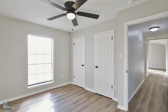 unfurnished bedroom with wood-type flooring and ceiling fan