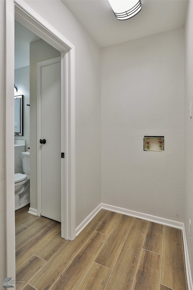 laundry room featuring hookup for a washing machine and light wood-type flooring