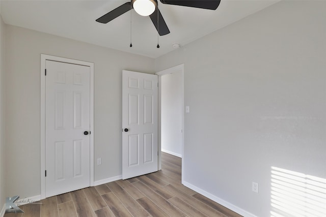 unfurnished bedroom with light hardwood / wood-style floors and ceiling fan