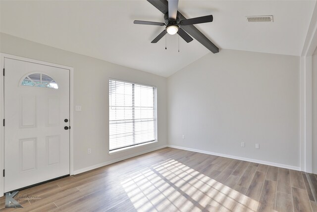 foyer entrance featuring light hardwood / wood-style flooring, vaulted ceiling with beams, and ceiling fan