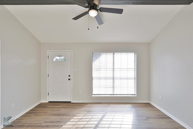 foyer with light hardwood / wood-style flooring, vaulted ceiling, and ceiling fan