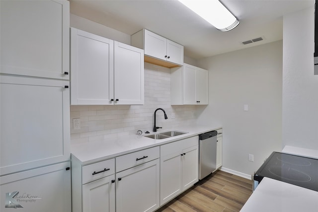 kitchen featuring dishwasher, sink, range, white cabinets, and light hardwood / wood-style floors