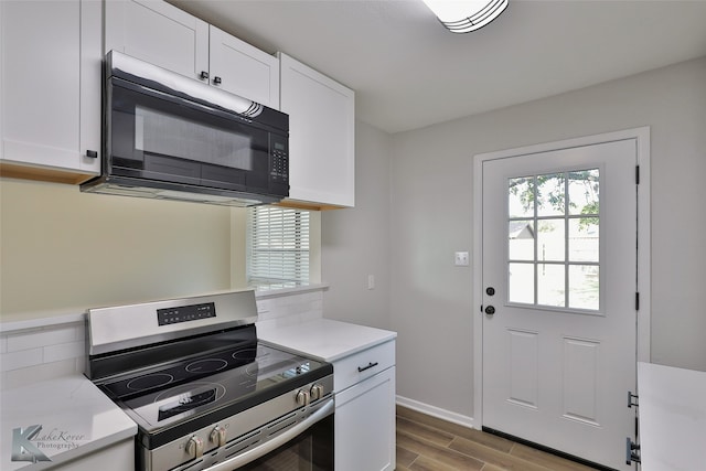 kitchen featuring stainless steel electric stove, light wood-type flooring, and white cabinets