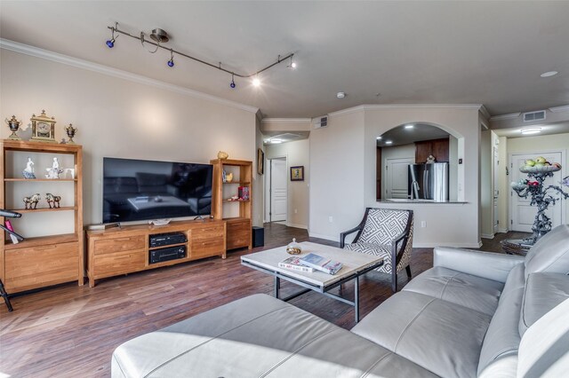 living room featuring hardwood / wood-style floors, crown molding, and track lighting