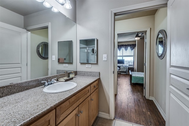 bathroom featuring vanity, tile patterned flooring, and ceiling fan