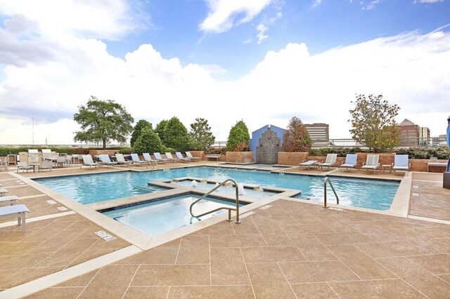 view of patio featuring an outdoor living space with a fireplace and an outdoor kitchen