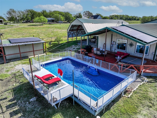 view of pool featuring a patio area, outdoor lounge area, and a lawn