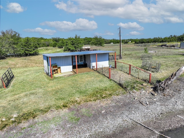 view of front facade with a front lawn and a rural view