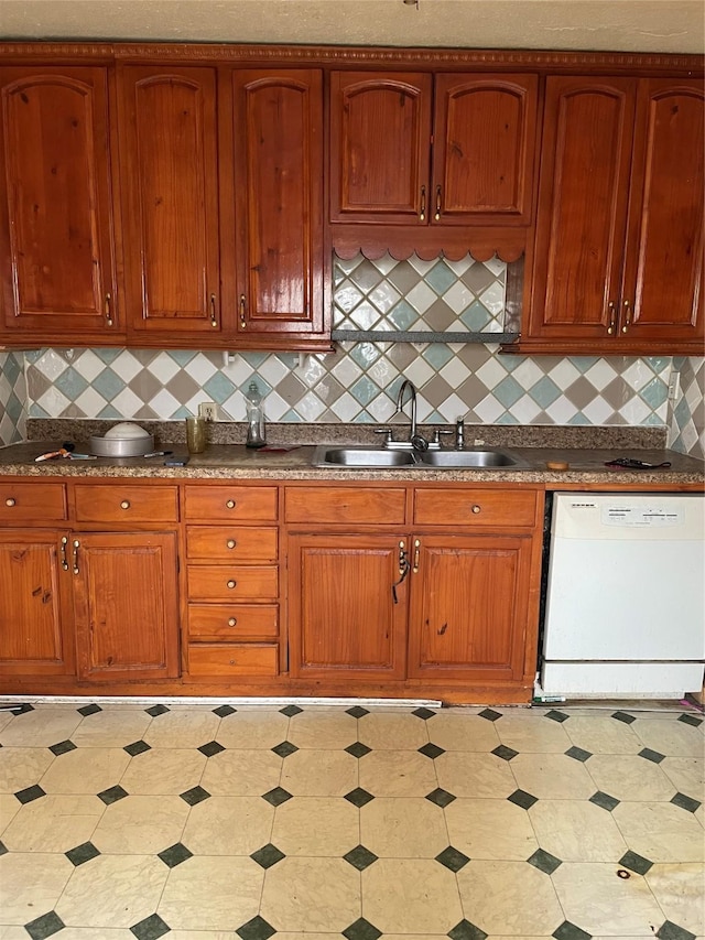 kitchen with white dishwasher, sink, and decorative backsplash