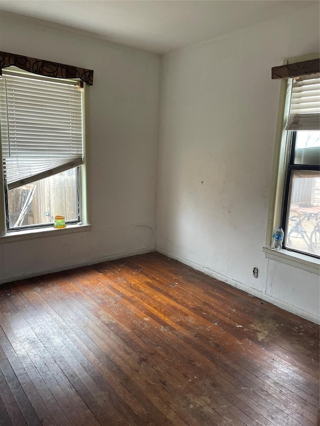 unfurnished room with dark hardwood / wood-style flooring