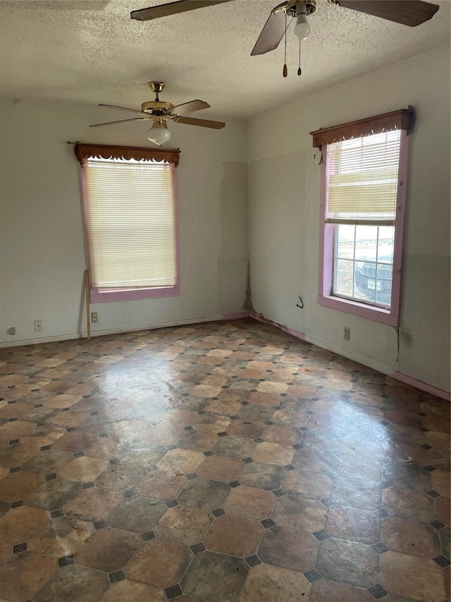 unfurnished room featuring a textured ceiling and ceiling fan