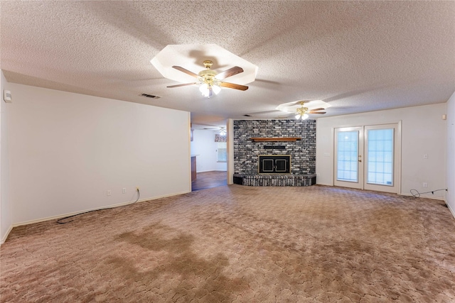 1490 Farm Rd Unit 2120, Clarksville, TX 75426 - unfurnished living room with a brick fireplace, carpet, a textured ceiling, and ceiling fan