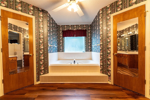 1490 Farm Rd Unit 2120, Clarksville, TX 75426 - bathroom featuring wallpapered walls, wood finished floors, baseboards, a garden tub, and ceiling fan