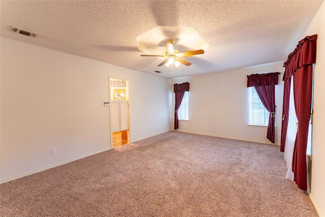 unfurnished room featuring a textured ceiling, light colored carpet, and ceiling fan