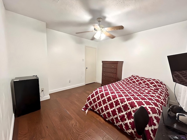 bedroom with dark wood-type flooring and ceiling fan