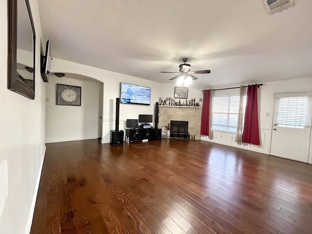 unfurnished living room with hardwood / wood-style floors, a fireplace, and ceiling fan