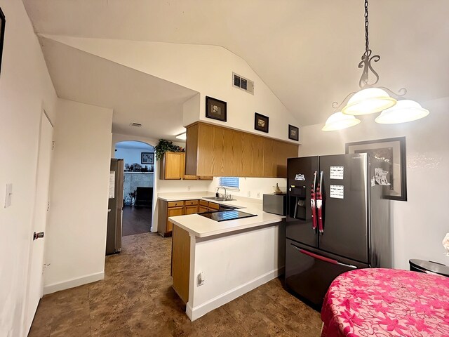 kitchen featuring black electric cooktop, kitchen peninsula, sink, stainless steel fridge with ice dispenser, and decorative light fixtures