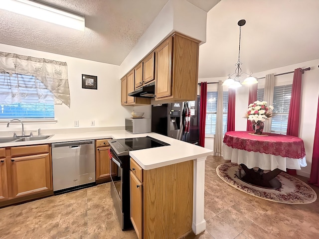 kitchen with appliances with stainless steel finishes, sink, a textured ceiling, kitchen peninsula, and hanging light fixtures