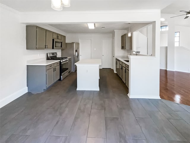 kitchen with a kitchen island, ceiling fan, stainless steel appliances, vaulted ceiling, and dark hardwood / wood-style floors