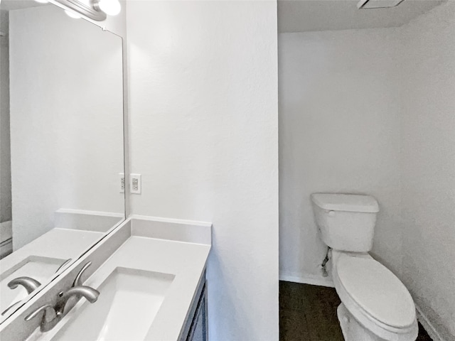 bathroom featuring toilet and vanity