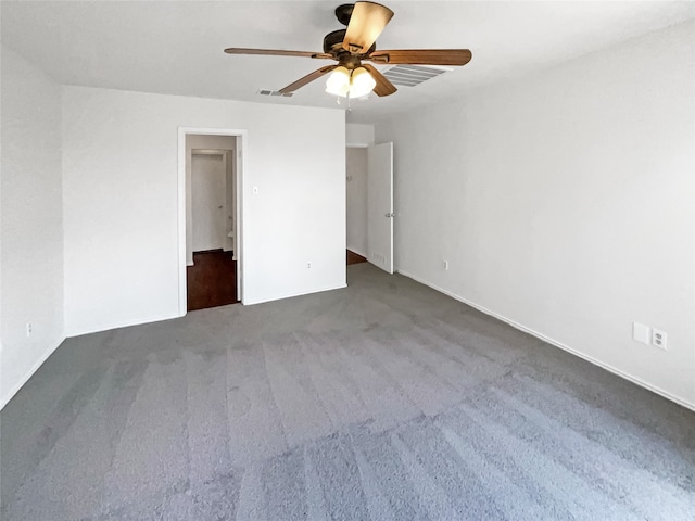 unfurnished bedroom with dark carpet and ceiling fan