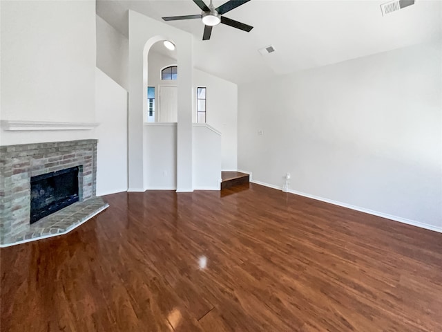 unfurnished living room featuring hardwood / wood-style floors, ceiling fan, a fireplace, and vaulted ceiling