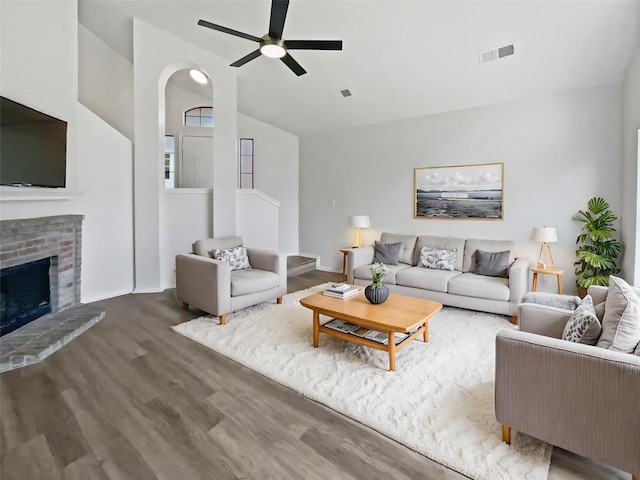 5103 Whitehaven Dr, Garland, TX 75043 - living room with wood finished floors, ceiling fan, vaulted ceiling, a fireplace, and baseboards