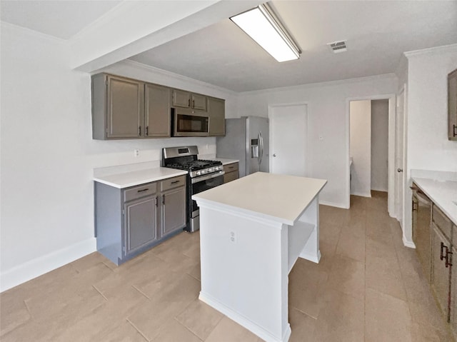 5103 Whitehaven Dr, Garland, TX 75043 - kitchen featuring appliances with stainless steel finishes, gray cabinetry, light countertops, a center island, and ornamental molding
