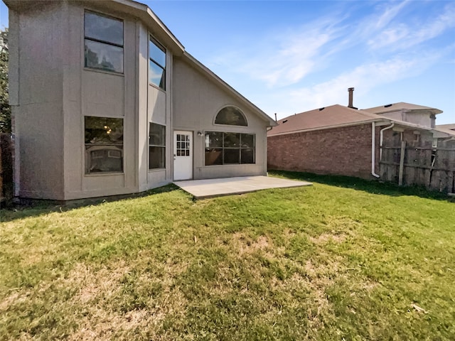 back of house featuring a patio and a lawn