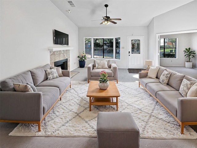 living room featuring lofted ceiling, carpet flooring, a healthy amount of sunlight, and ceiling fan