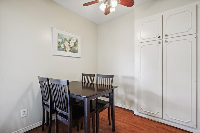 dining area featuring dark wood-type flooring and ceiling fan