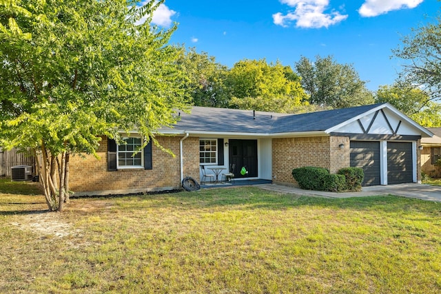 view of front of house featuring a garage, central AC, and a front lawn