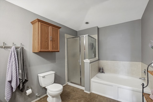 bathroom featuring tile patterned flooring, toilet, and shower with separate bathtub