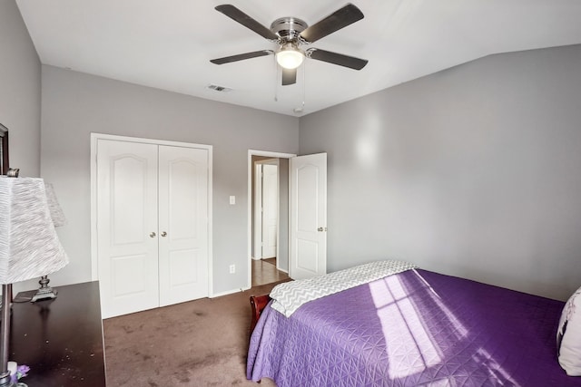 bedroom featuring a closet, ceiling fan, vaulted ceiling, and dark carpet