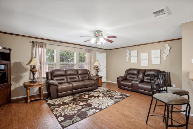 living room with crown molding, hardwood / wood-style flooring, and ceiling fan