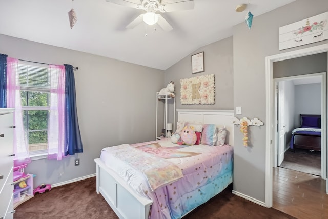 bedroom featuring dark hardwood / wood-style floors, vaulted ceiling, and ceiling fan