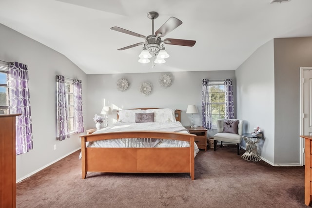 bedroom with ceiling fan, lofted ceiling, and dark colored carpet