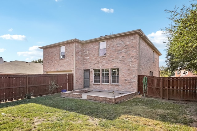 back of house featuring a yard and a patio