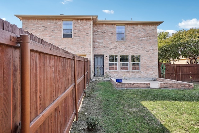 rear view of house featuring a yard