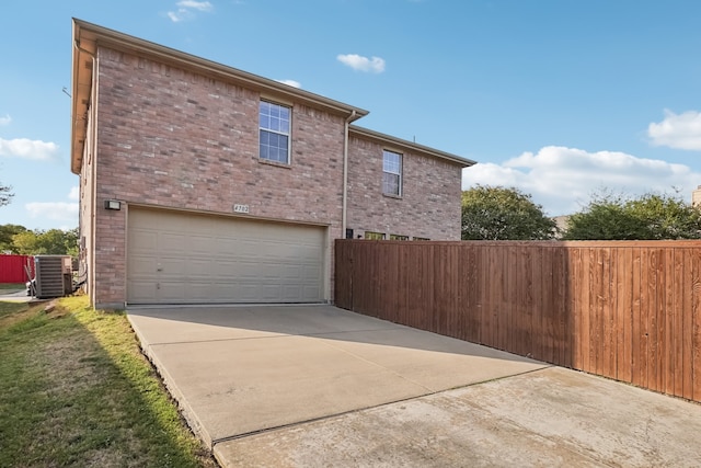 view of home's exterior featuring cooling unit and a garage