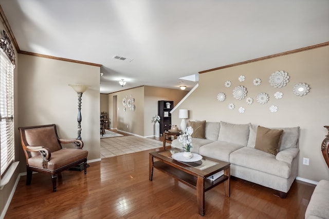 living room with ornamental molding and hardwood / wood-style floors