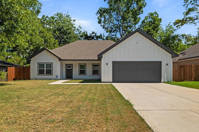 view of front of home with a front yard and a garage