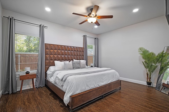 bedroom with dark wood-type flooring, ceiling fan, and multiple windows