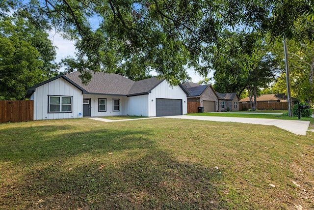 ranch-style home featuring a front yard and a garage