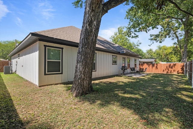 back of house featuring a patio, a lawn, and central air condition unit