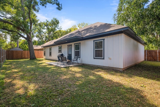 back of property featuring a patio area and a lawn