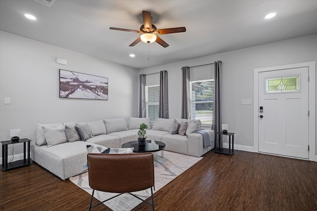 living room featuring ceiling fan and dark hardwood / wood-style flooring