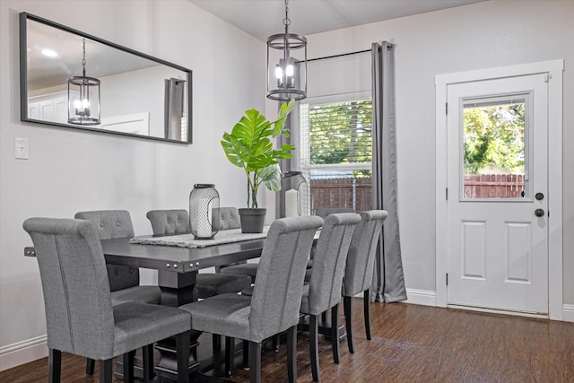 dining space featuring a chandelier and dark hardwood / wood-style flooring